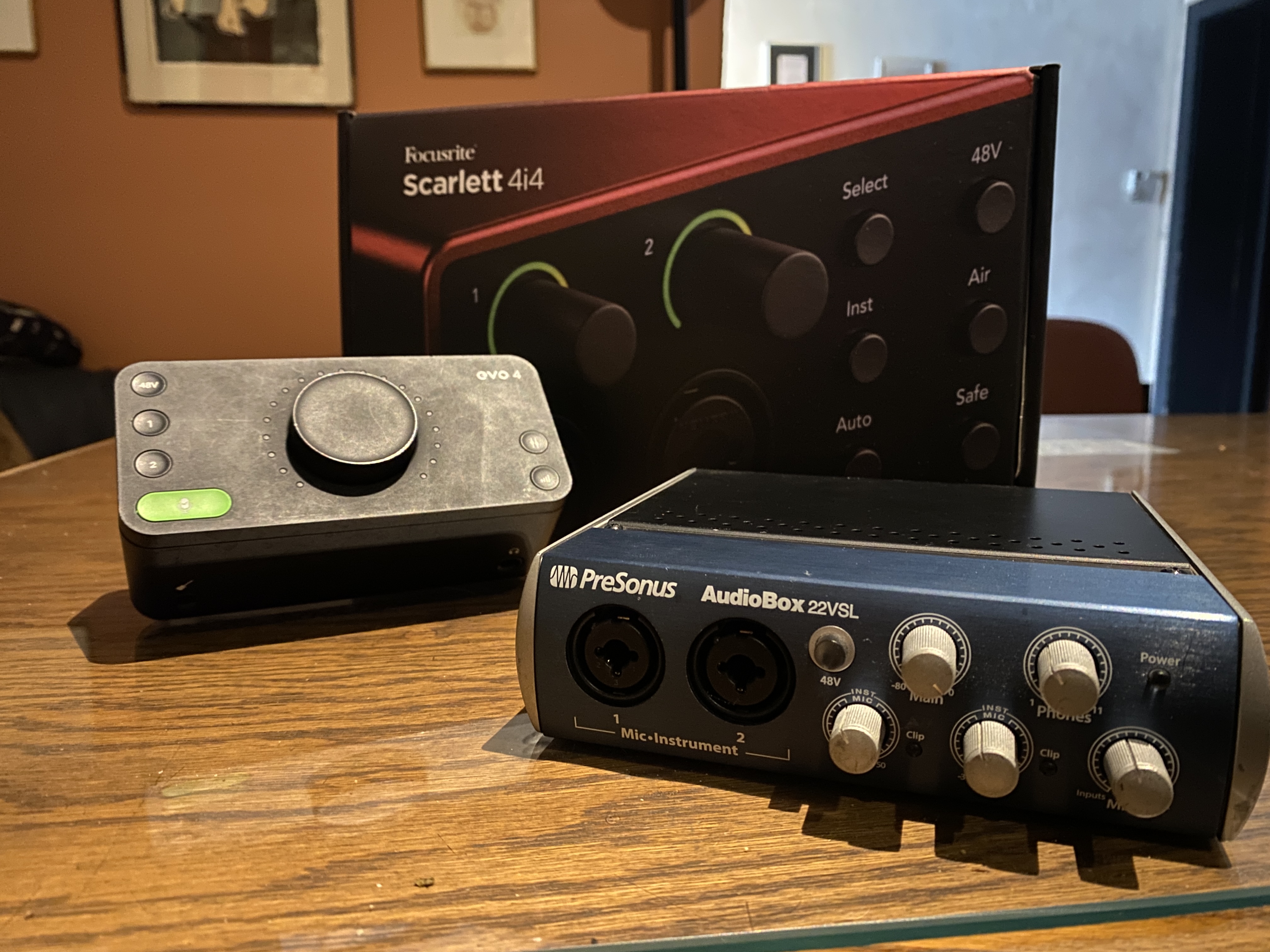 Common interfaces for home studios include the Focusrite Scarlett, Audient EVO, and PreSonus AudioBox.